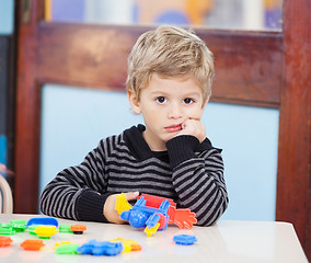 Image showing Unhappy Boy With Blocks In Classroom