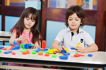 Image showing Children Playing With Construction Blocks At Desk