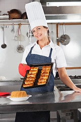 Image showing Female Chef Holding Tray Of Baked Breads