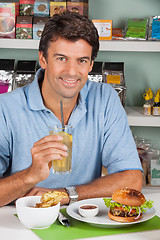 Image showing Man With Drink And Burger In Supermarket