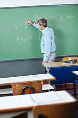 Image showing Male Teacher Writing On Greenboard