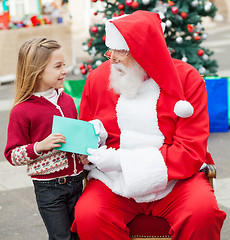 Image showing Girl Giving Wish List To Santa Claus