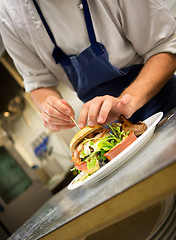 Image showing Chef Preparing Gourmet Hamburger