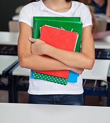 Image showing Midsection Of Schoolgirl Holding Books