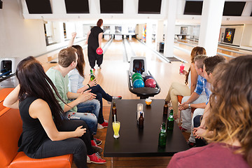 Image showing Friends Looking At Woman Bowling in Club