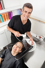 Image showing Hairstylist Washing Client's Hair In Parlor