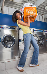 Image showing Woman Carrying Heavy Basket Of Clothes