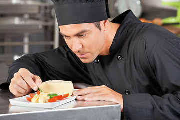 Image showing Male Chef Garnishing Dish