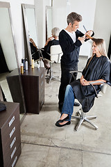 Image showing Hairdresser Cutting Client's Hair In Parlor