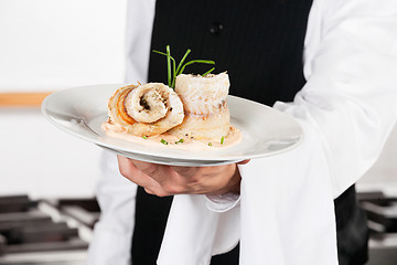 Image showing Waiter Presenting Salmon Roll