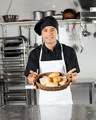 Image showing Young Chef Holding Basket Of Breads