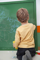 Image showing Boy Writing On Chalkboard At Kindergarten