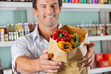 Image showing Male Customer Showing Bellpeppers In Paper Bag