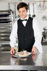 Image showing Waiter With Salmon Roll And White Wine