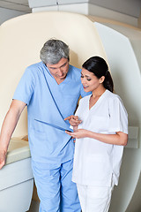 Image showing Technicians Standing by MRI Machine