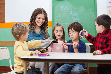 Image showing Children And Teacher Playing With Musical Instruments