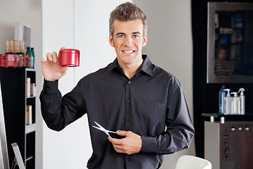 Image showing Hairstylist With Scissors Presenting Hairgel Bottle