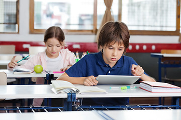 Image showing Schoolboy Using Digital Tablet In Classroom