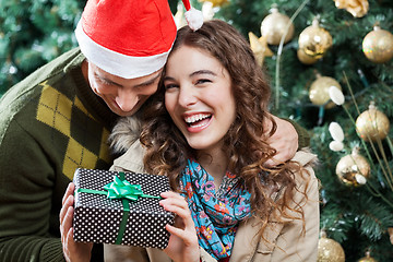 Image showing Cheerful Couple With Christmas Present In Store