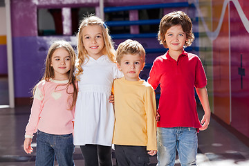 Image showing Children Standing Arms Around In Kindergarten