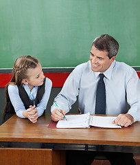 Image showing Professor And Little Girl Looking At Each Other At Desk