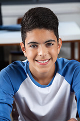 Image showing Teenage Schoolboy Sitting In Classroom