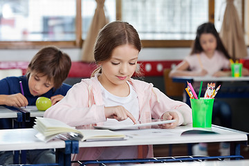 Image showing Schoolgirl Using Digital Tablet At Desk