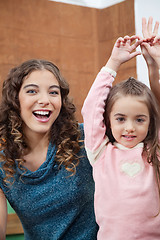 Image showing Teacher And Little Girl With Hands Raised