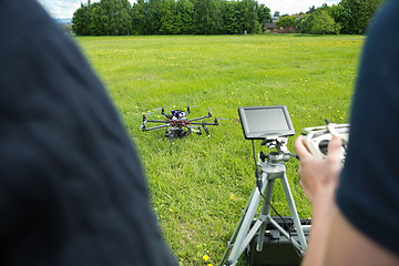 Image showing Technicians Operating UAV Helicopter in Park