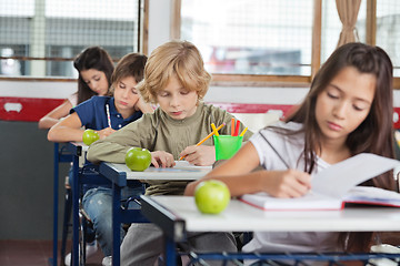 Image showing Schoolchildren Studying At Desk