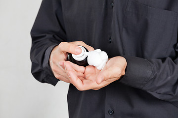 Image showing Barber Spraying Shaving Foam On Palm