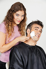 Image showing Scared Man Being Shaved By Female Barber