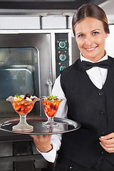 Image showing Happy Waitress Holding Dessert Tray