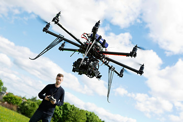 Image showing Technician Flying UAV Helicopter in Park