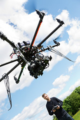 Image showing Male Engineer Flying UAV Helicopter