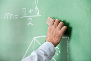 Image showing Male Teacher'S Hand Wiping Board With Duster