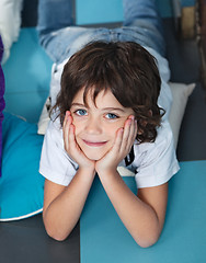 Image showing Boy With Head In Hands Lying On Floor In Preschool