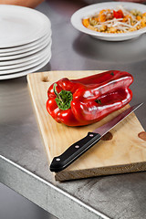 Image showing Red Bellpepper And Knife On Cutting Board