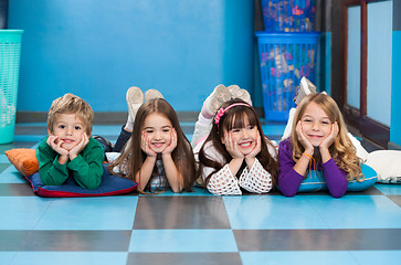 Image showing Children Lying In A Row On Floor In Classroom