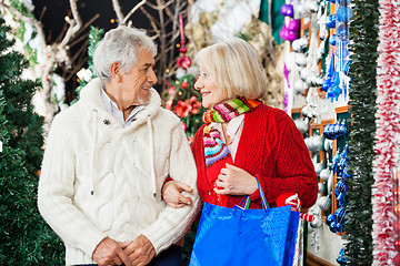 Image showing Senior Couple With Shopping Bags At Christmas Store