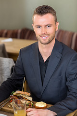 Image showing Young Businessman With Sandwich And Juice