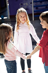 Image showing Children Playing While Holding Hands In Preschool