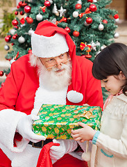 Image showing Santa Claus Giving Gift To Girl