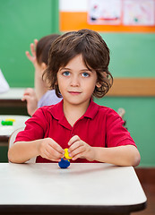 Image showing Boy Holding Clay Model At Desk