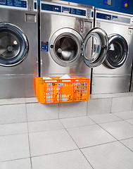 Image showing Basket Of Clothes In Front Of Washing Machine