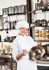 Image showing Female Chef Mixing Egg With Wire Whisk In Bowl