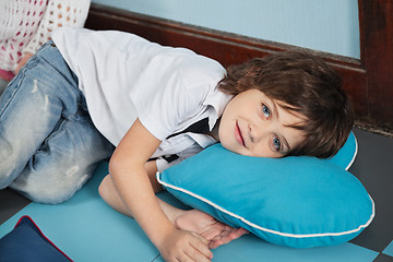 Image showing Boy Lying On Heartshaped Pillow In