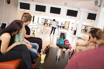 Image showing Friends Watching Woman Bowling in Alley