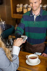 Image showing Woman Making Payment Through Mobilephone