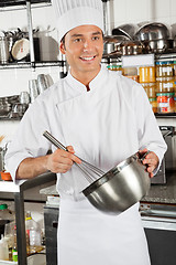 Image showing Male Chef Whisking Egg In Kitchen